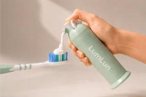 LumLun airless toothpaste pump bottle dispensing toothpaste onto a toothbrush for clean daily oral care