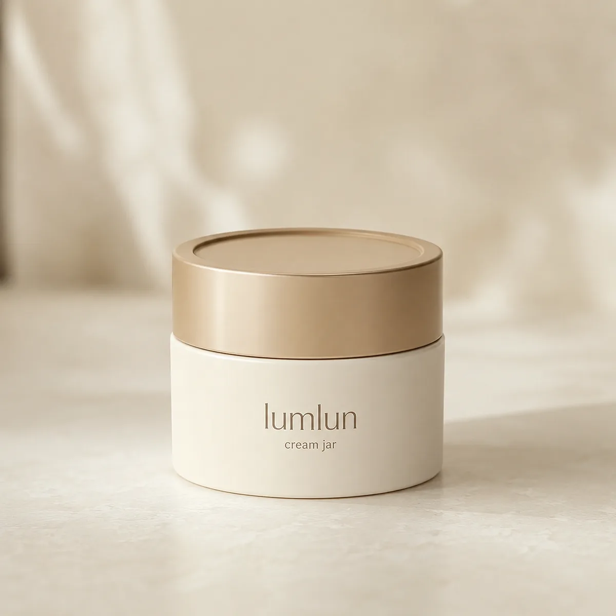 Lumlun dual-wall PP cream jar with an ivory body and gold-tone screw cap.