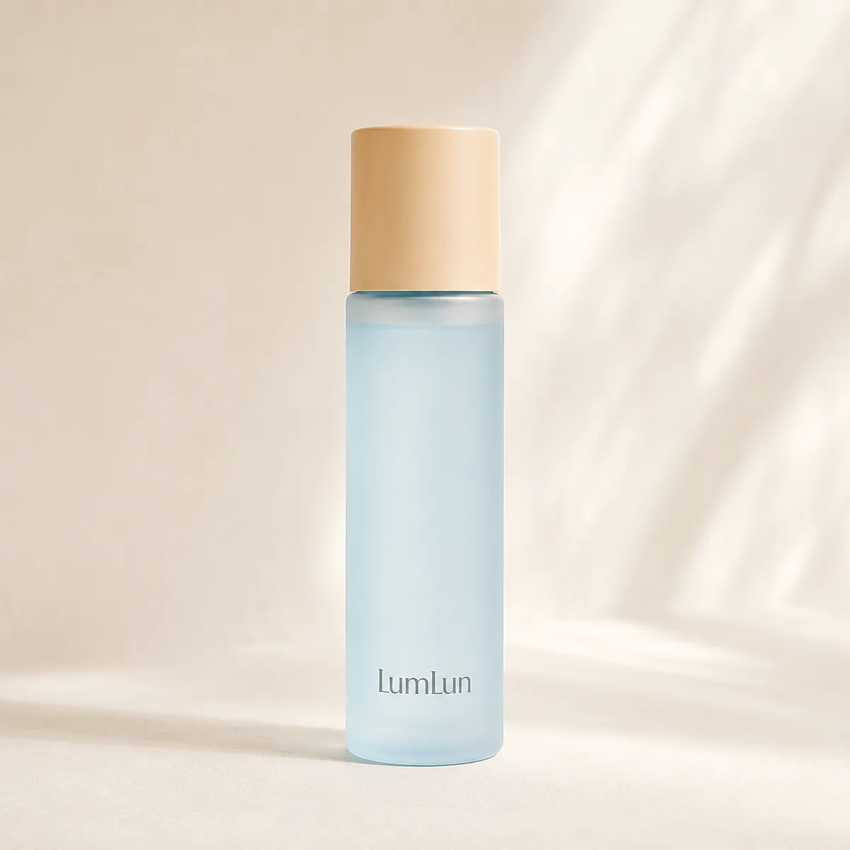 A single light blue toner bottle with beige cap displayed in soft studio lighting with shadows