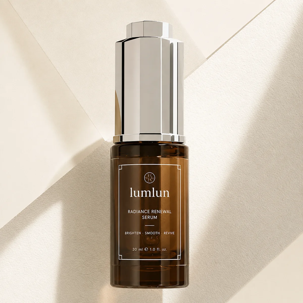 LumLun single brown push-button dropper bottle with silver cap displayed on minimal beige studio background