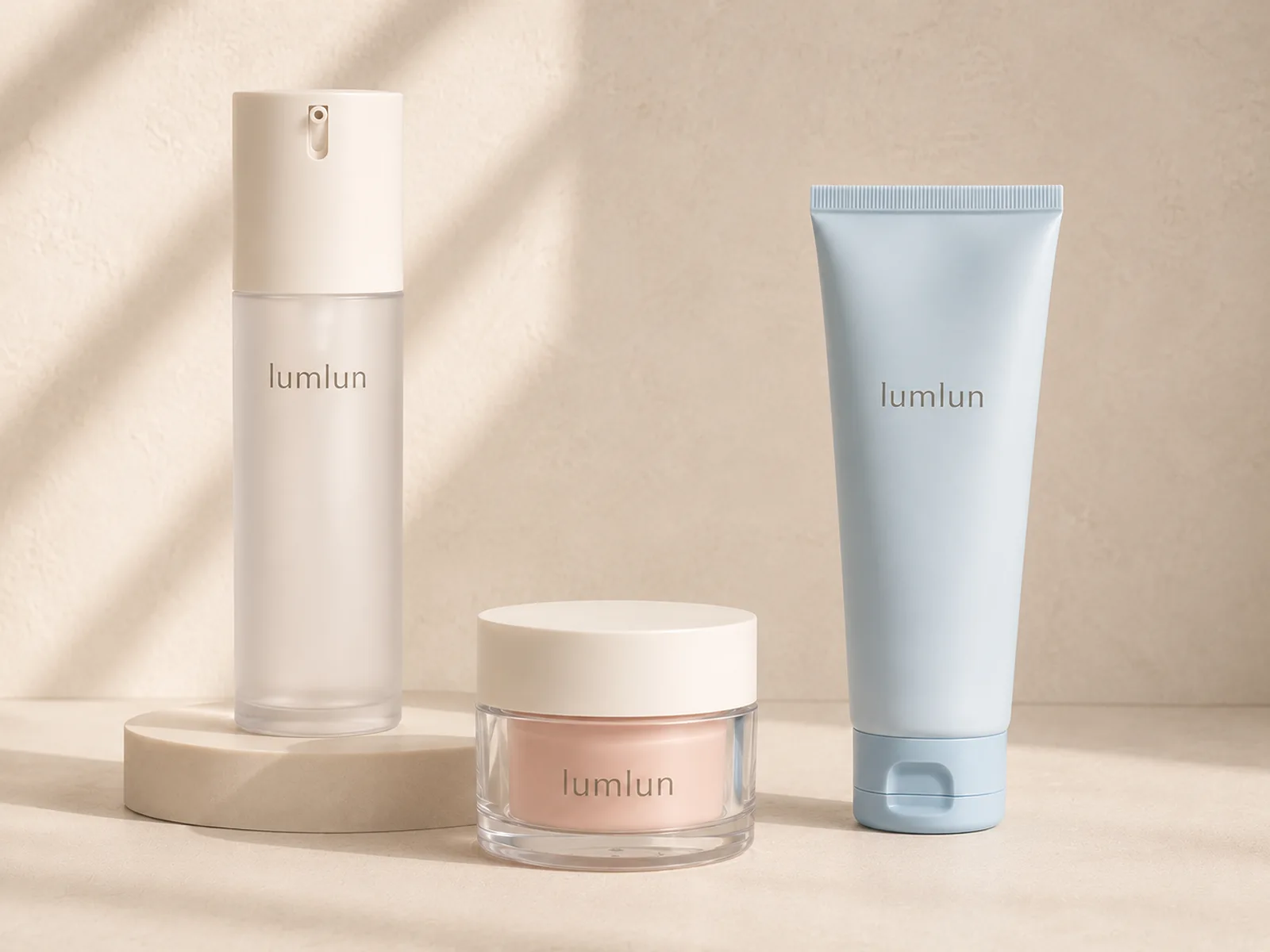 LumLun skincare packaging direction with a frosted pump bottle, thick-wall cream jar, and blue cosmetic tube