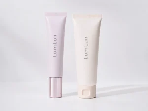 LumLun airless pump tube beside a standard squeeze tube for skincare packaging.