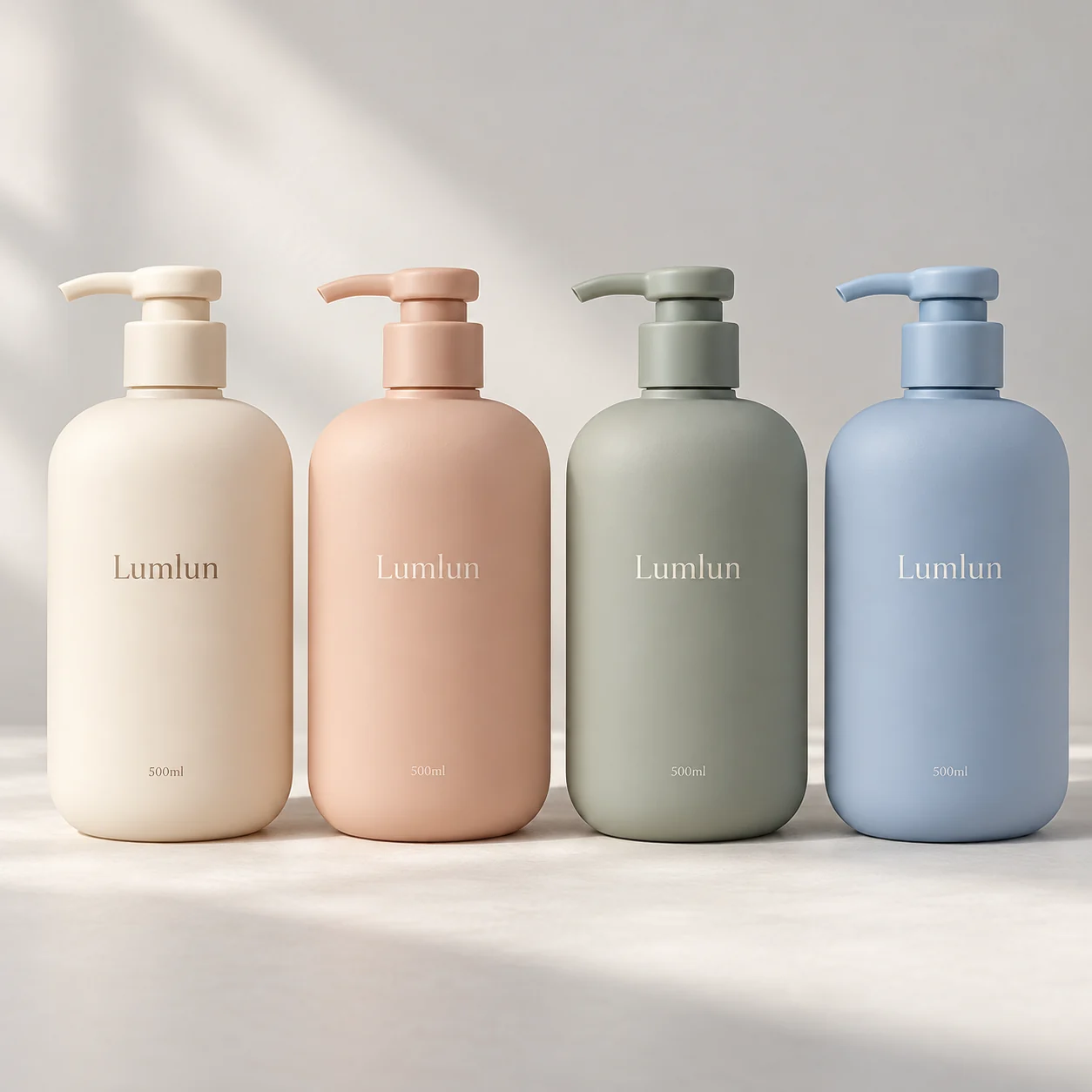 Four pastel 500ml PE pump bottles with LumLun logos in cream, peach, sage green and blue