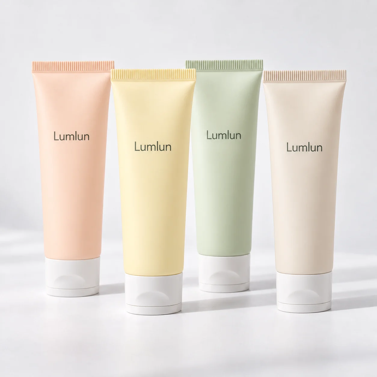 Four pastel 40mm facial cleanser tubes with translucent white flip-top caps