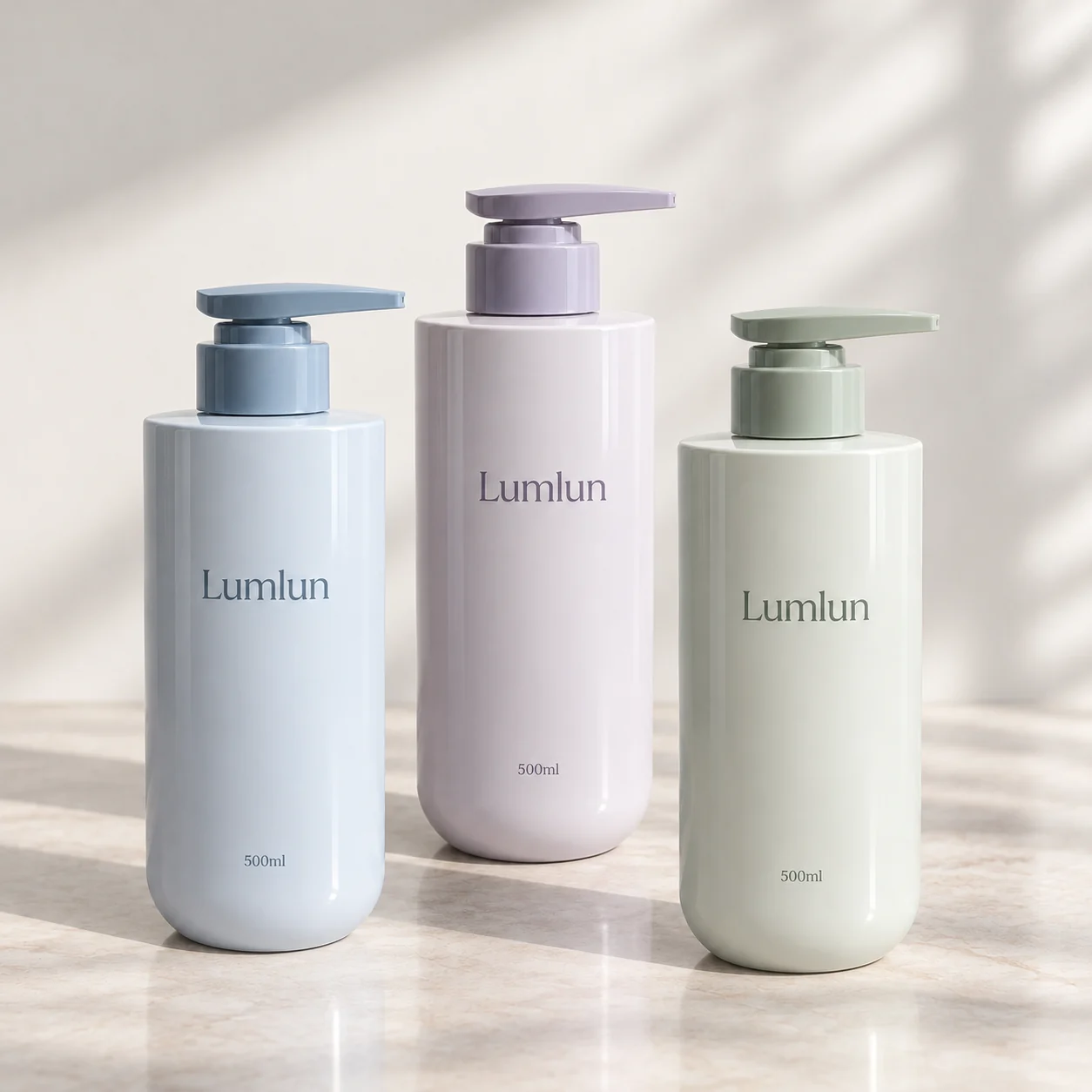 Three straight-shoulder PET pump bottles in blue, lavender and pale green