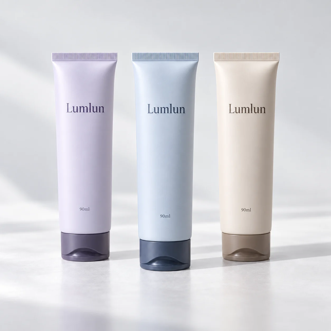 Three cleanser tubes in lavender, blue and cream with tinted translucent caps