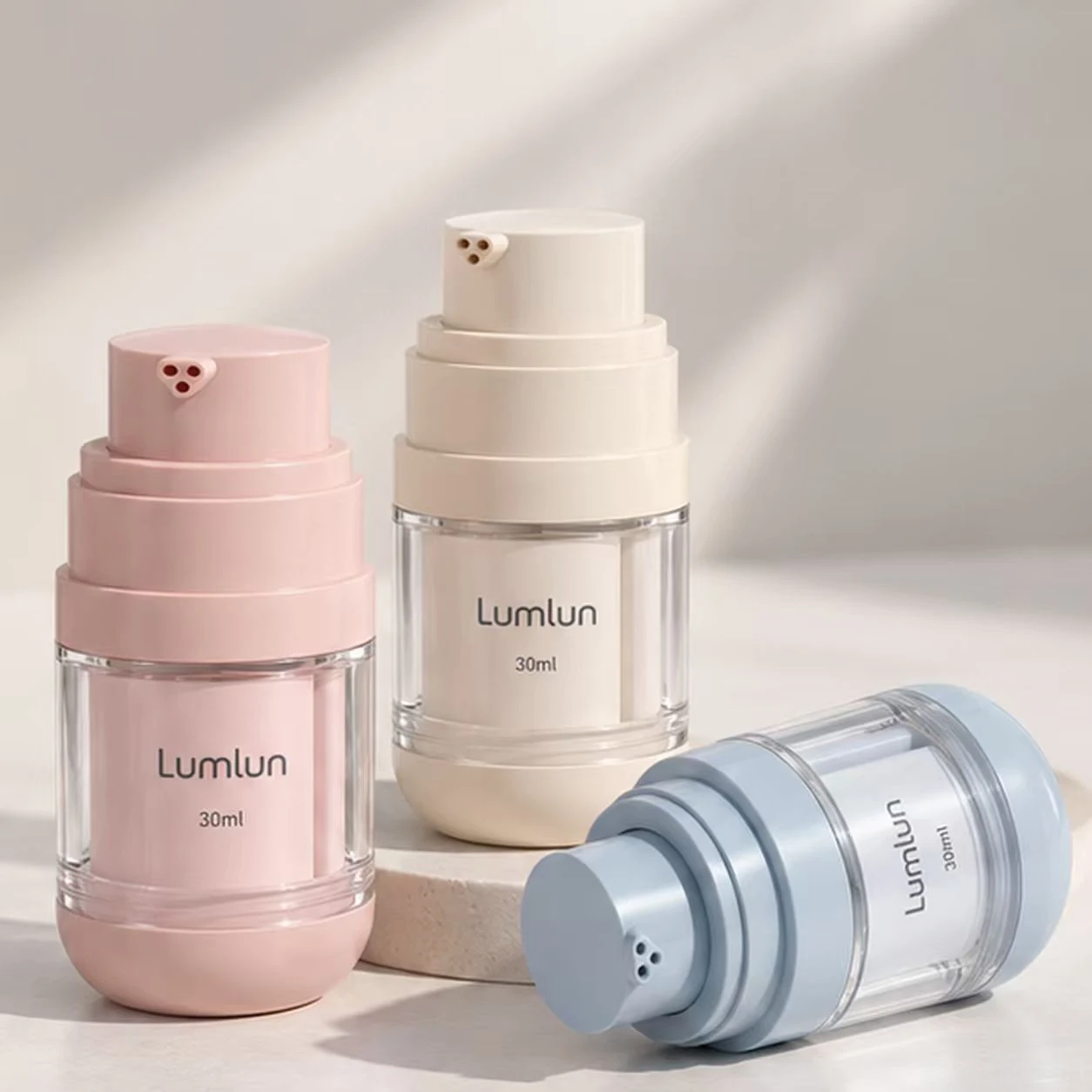 LumLun triple-chamber airless bottle close-up showing three outlet ports