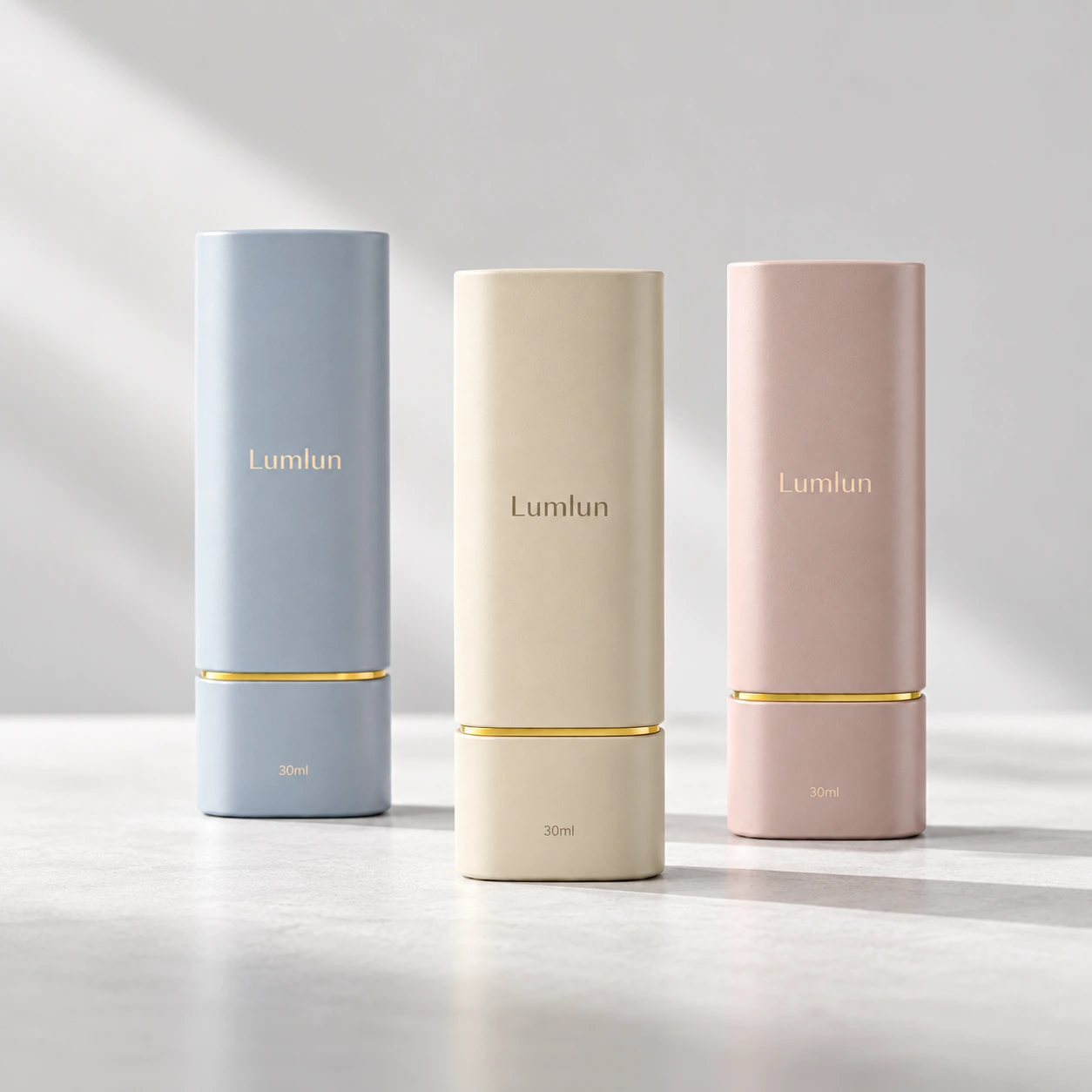 Three closed LumLun 30ml PP + ABS square twist-up airless bottles in blue, cream and pink