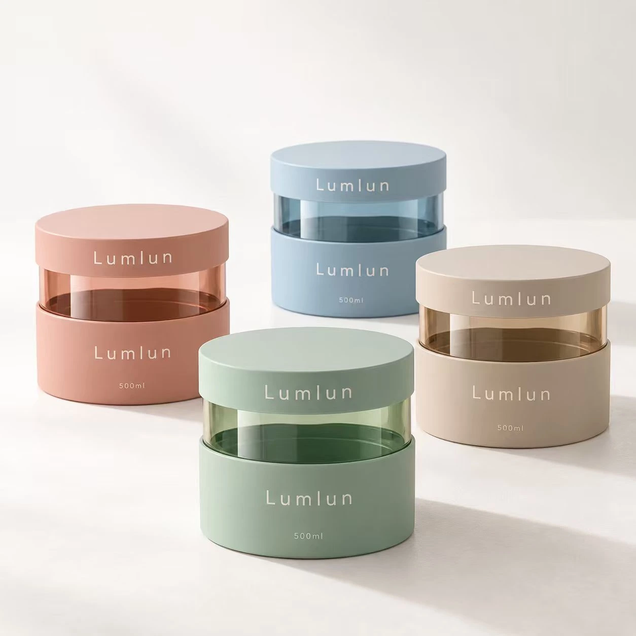 Cuatro tarros de crema con ventana transparente en rosa pastel, azul, beige y verde, todos de 500 ml.