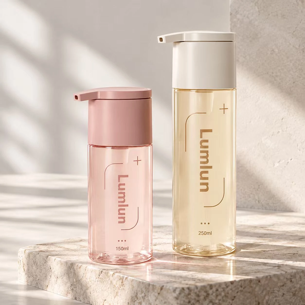 Two clear-window PET wash bottles in pink and pale yellow showing 150ml and 250ml sizes.