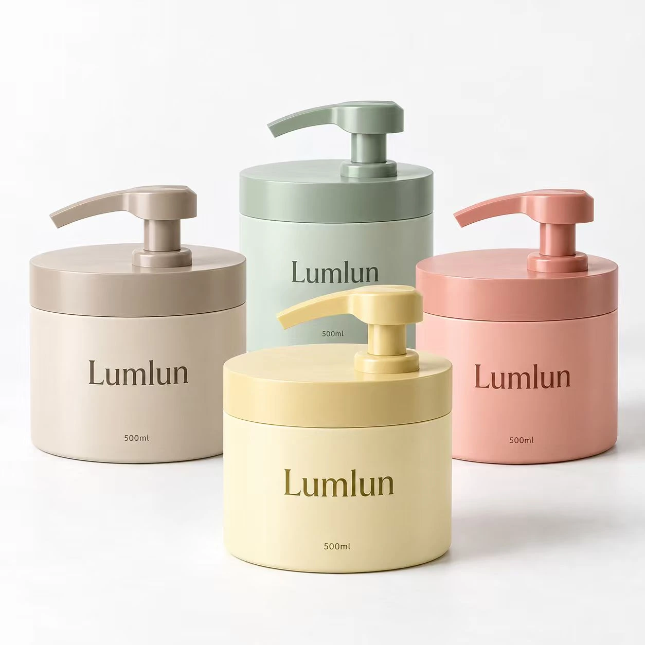 Cuatro envases PE anchos con bomba en beige, verde, amarillo y rosa pastel, todos de 500 ml.