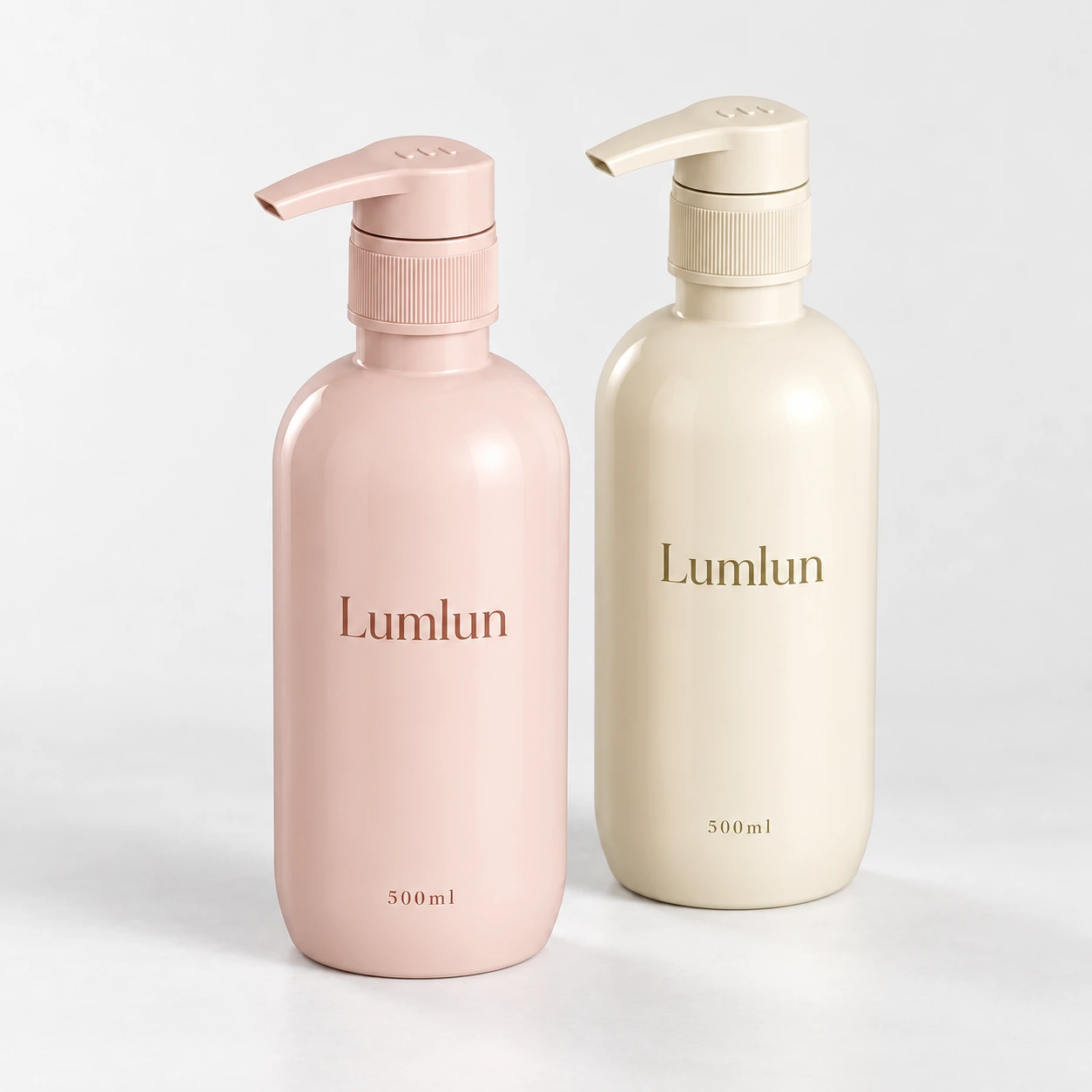 Two rounded 500ml PET pump bottles in soft pink and cream.